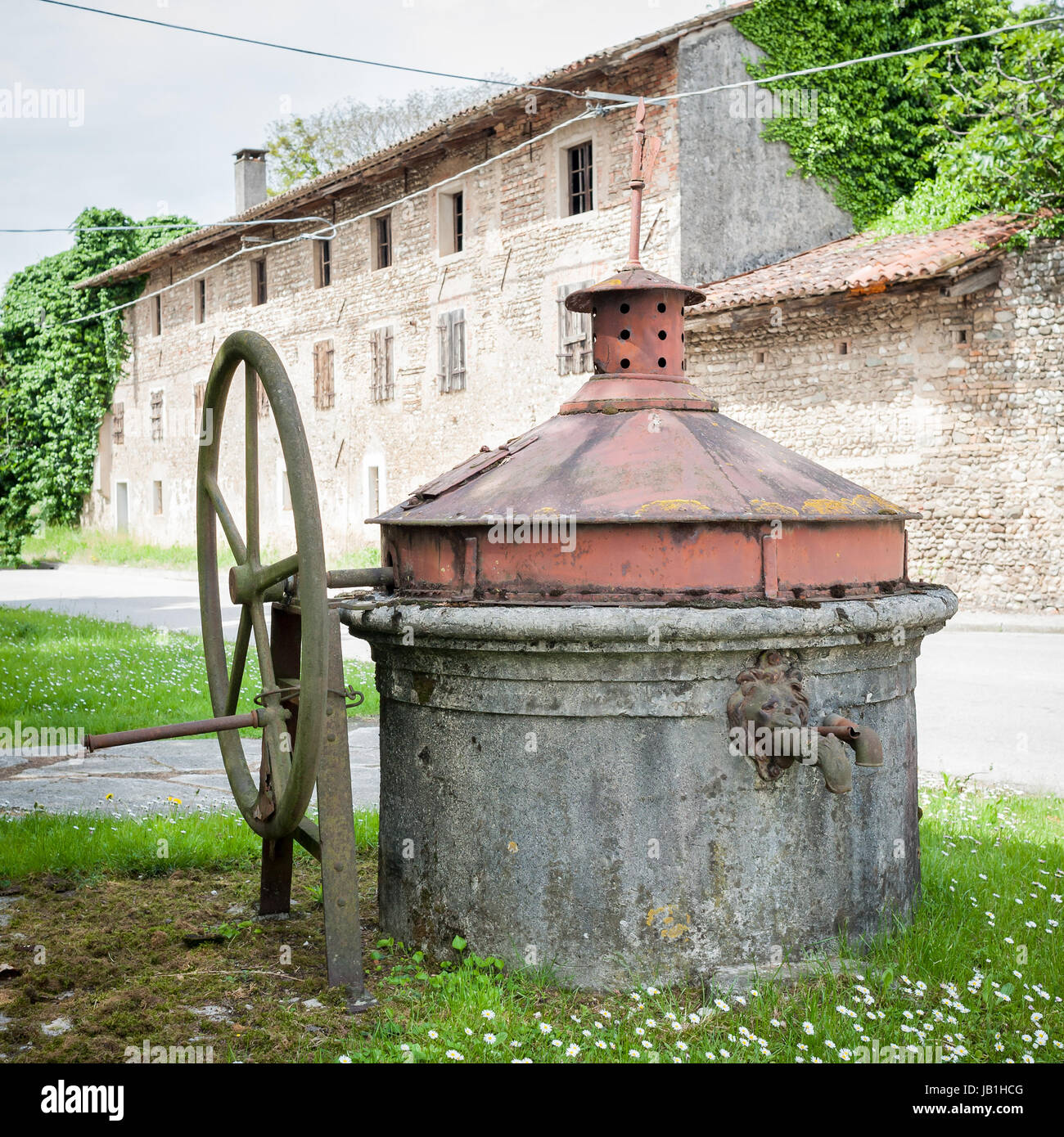 Old well covered with hand pump. It needed around the country. Stock Photo