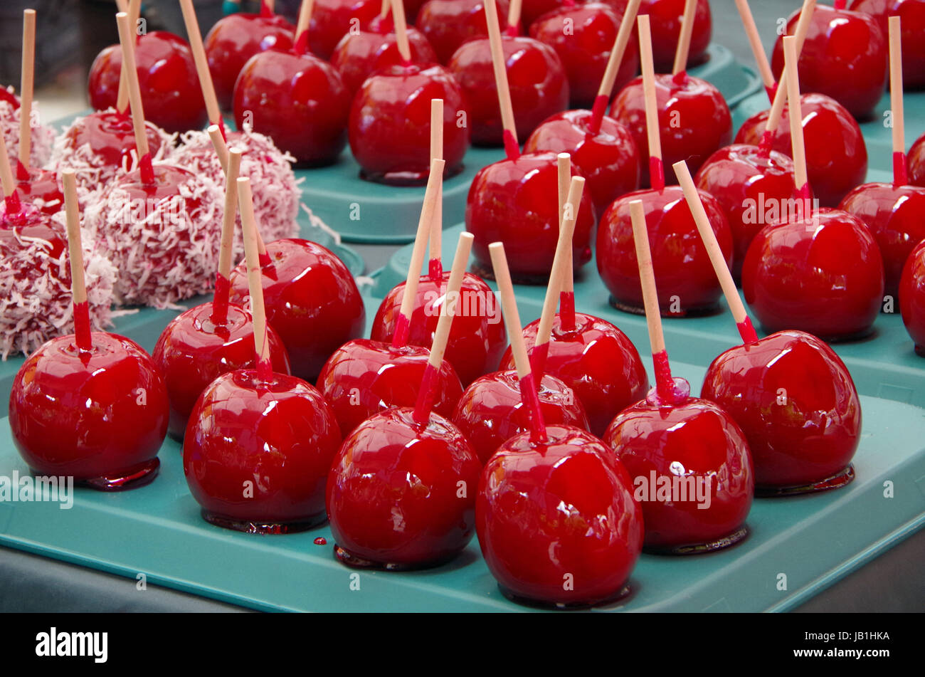 Red candy apples hand dipped in sticky sugar glaze Stock Photo