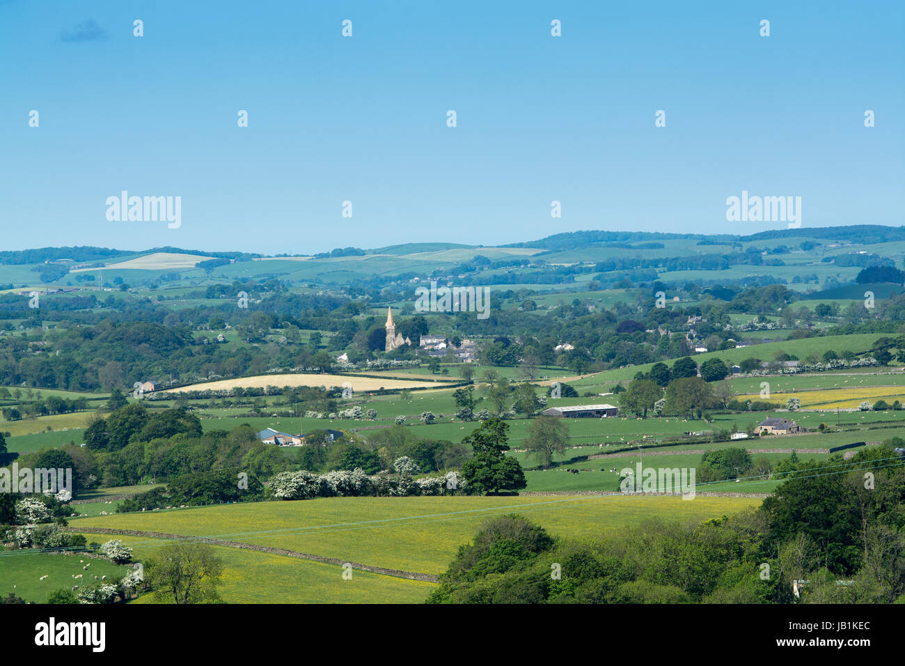 Rolling countryside in the Lune Valley, Lancashire, in early spring, with Burton in Lonsdale village visible. Stock Photo