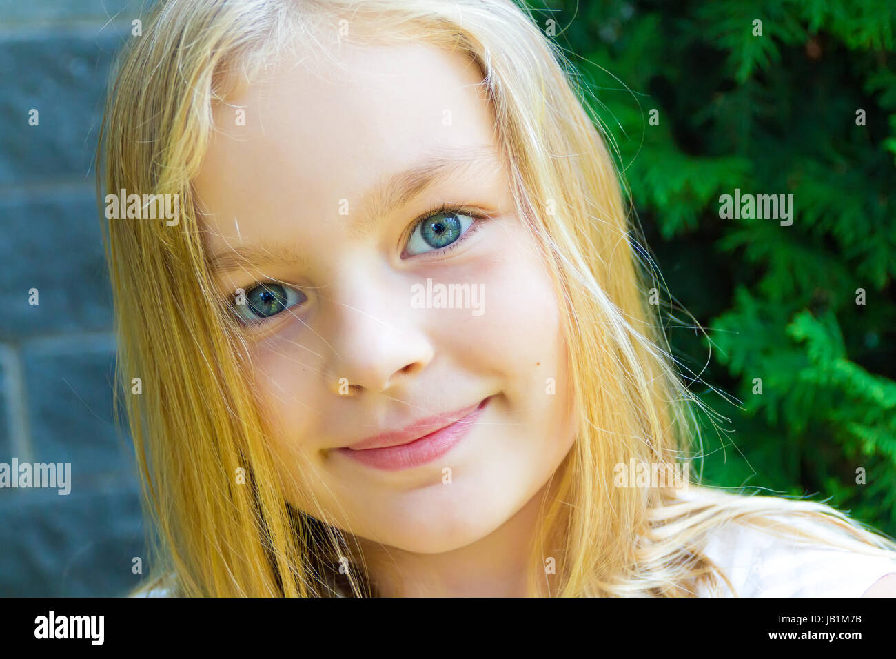 Cute girl with blond long hair and blue eyes Stock Photo - Alamy