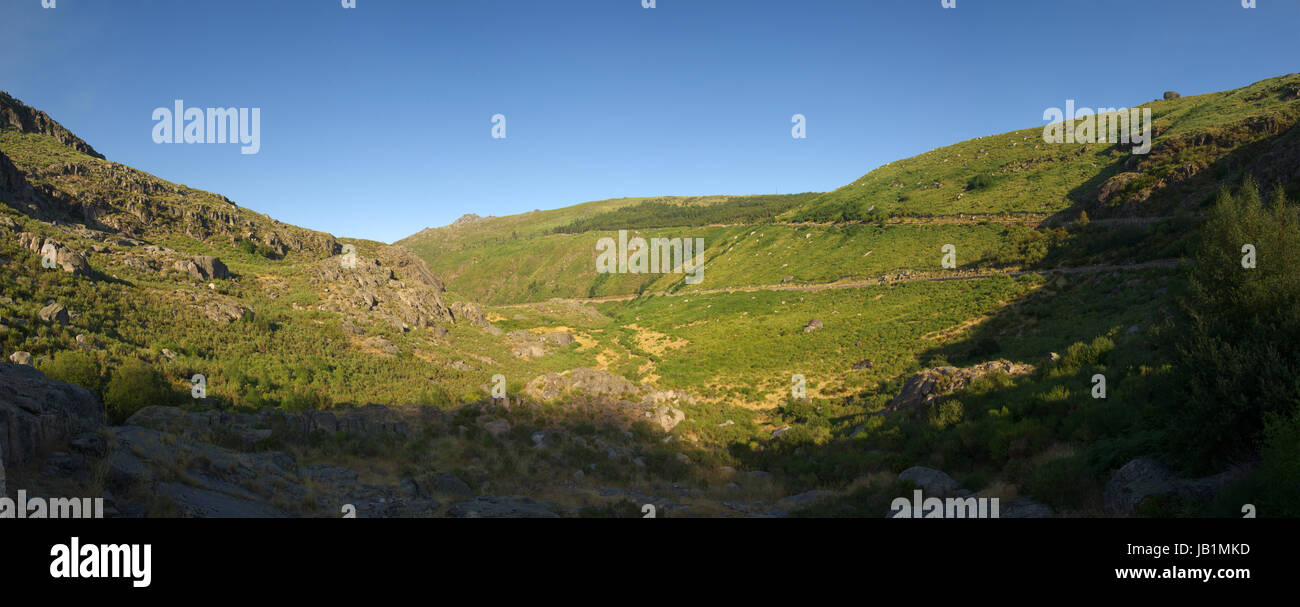 Panorama of green coloured glacial valley at Estrela mountain range (Serra da Estrela) near Manteigas. River Zerere runs at the bottom. Portugal. Stock Photo