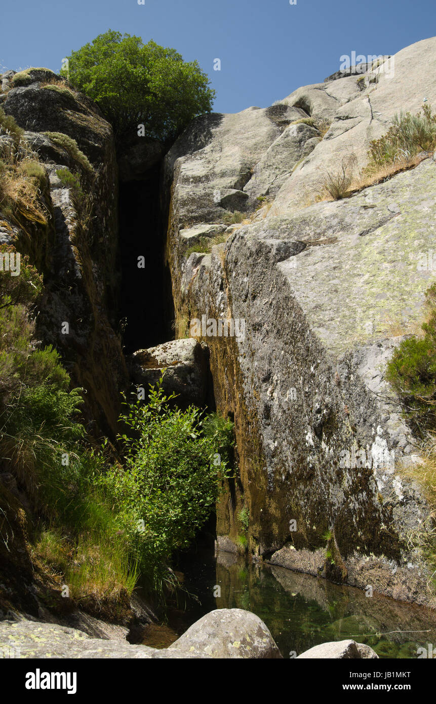Perpective of a crack in the rocks and a small pond: the birth place of River Zezere at Covao d'Ametade. Estrela mountain range (Serra da Estrela), Po Stock Photo