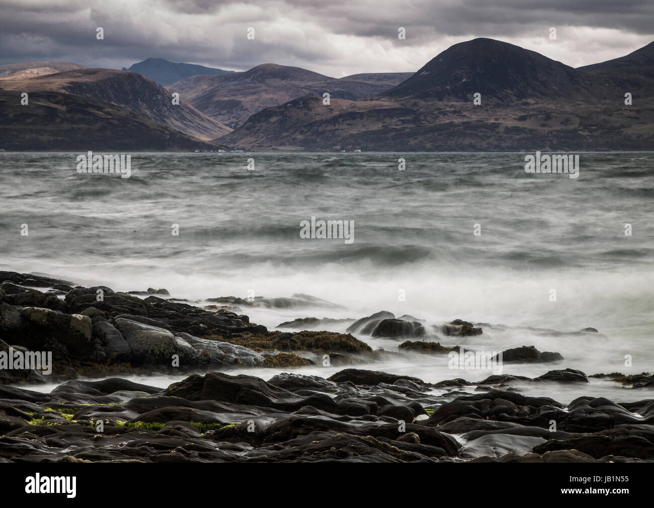 Arran seen from Kintyre shoreline in dramatic weather Stock Photo