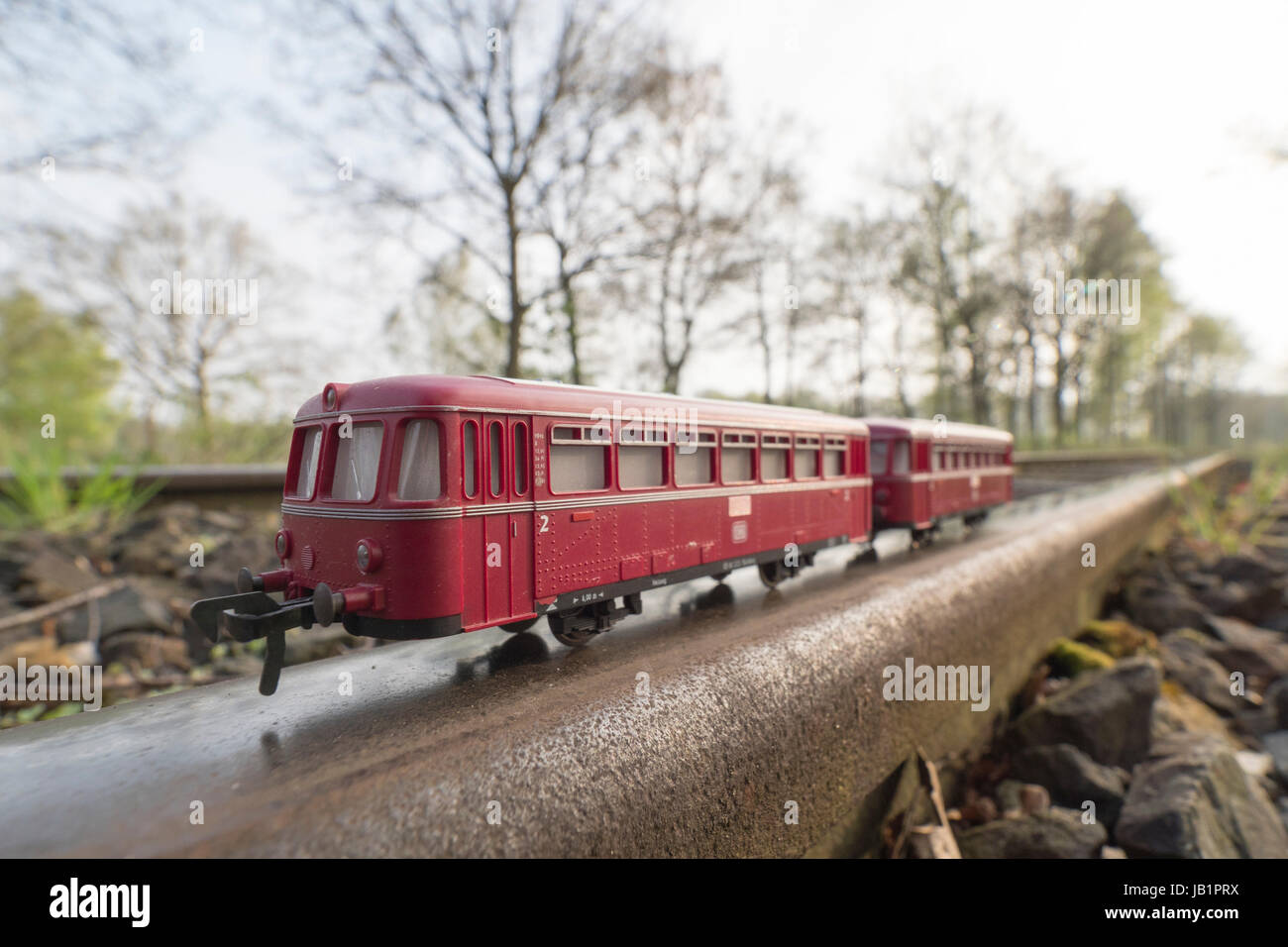 Red train model, bus-style train,  on real rails, original train served as local public transport, Celle, Germany Stock Photo