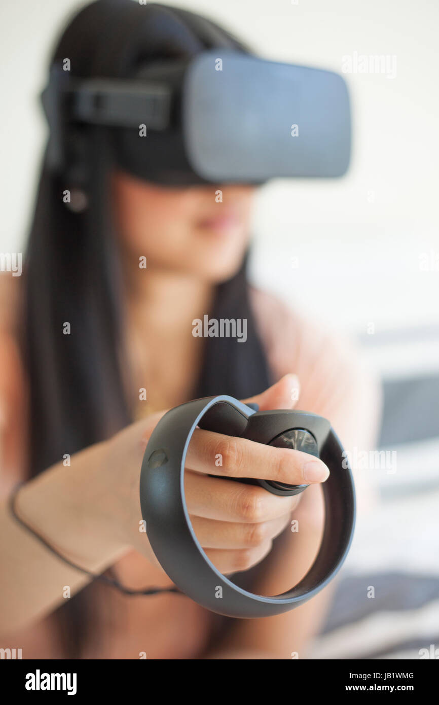 Young Asian female playing with Oculus Rift virtual reality headset Stock Photo