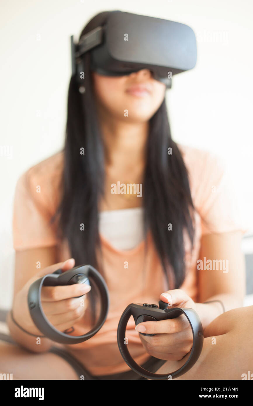 Young Asian girl wearing Oculus Rift virtual reality headset Stock Photo