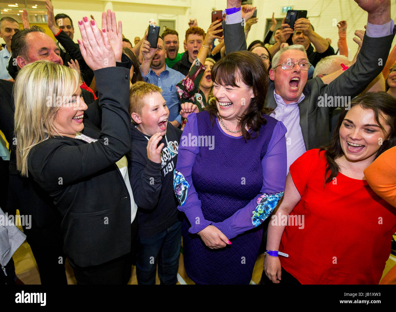 Newly elected Sinn Fein Fermanagh & South Tyrone MP Michelle Gildernew (third from right) is cheered on by Michelle O'Neill (left), Sean Lynch (second from right) and Jemma Dollan (right) at the Omagh Leisure Complex, Co Tyrone. Stock Photo