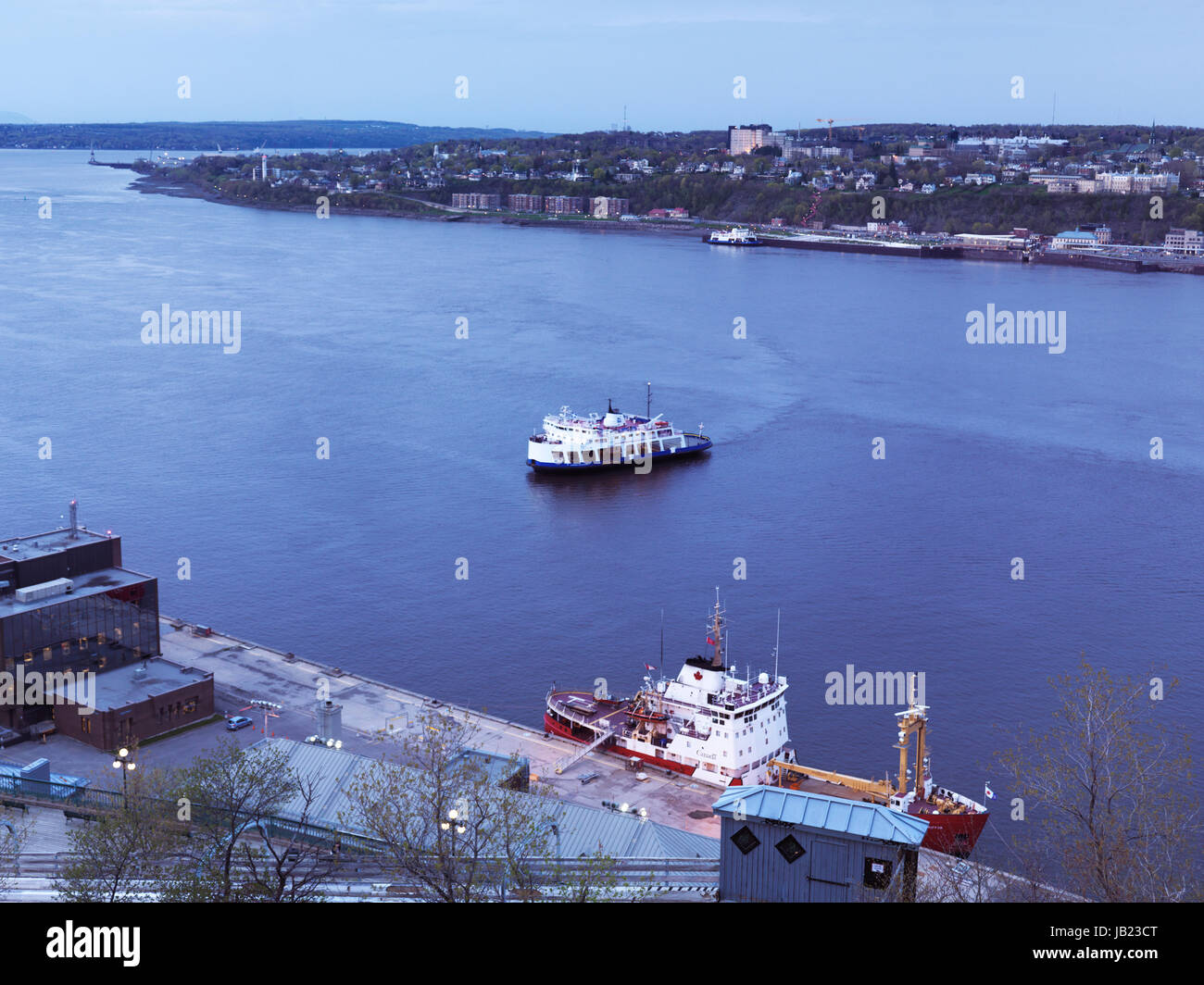 Ferry over St. Lawrence river at dusk, aerial view. Quebec City, Quebec