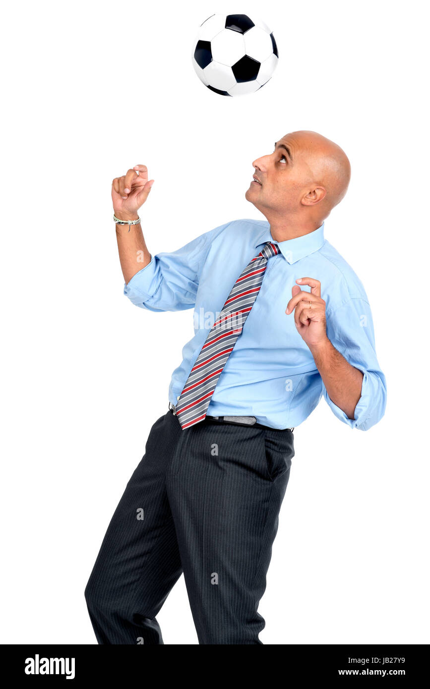 Businessman playing soccer ball isolated in white Stock Photo - Alamy