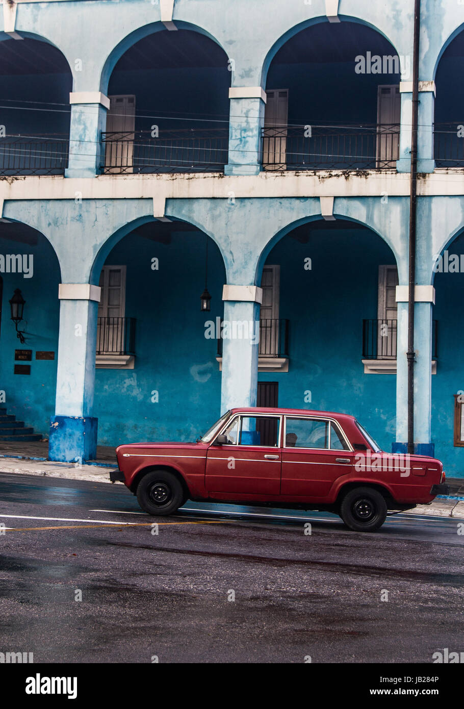 Picture of red old car in front of blue building Stock Photo - Alamy