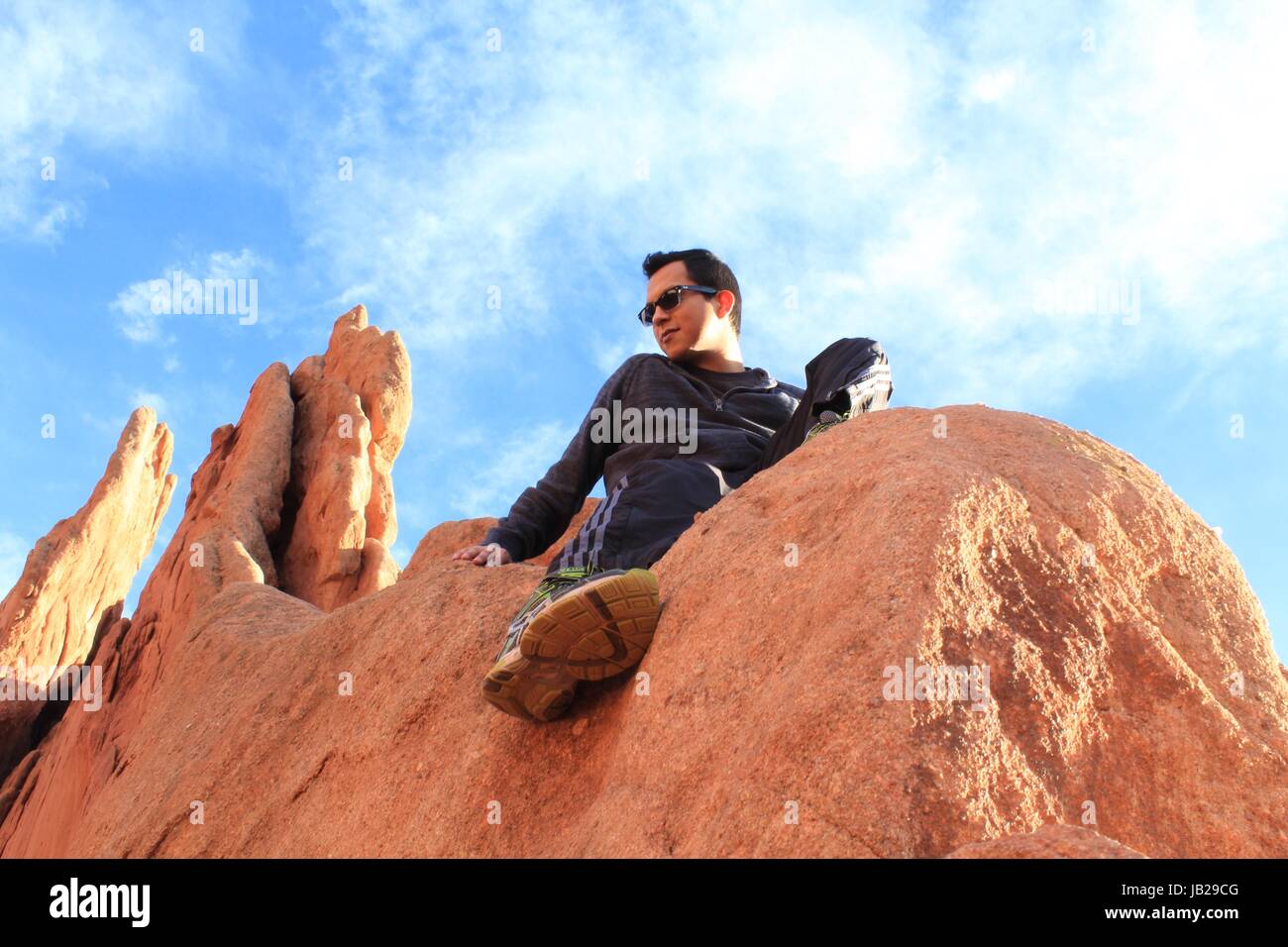 A young man sitting in a mountain Stock Photo