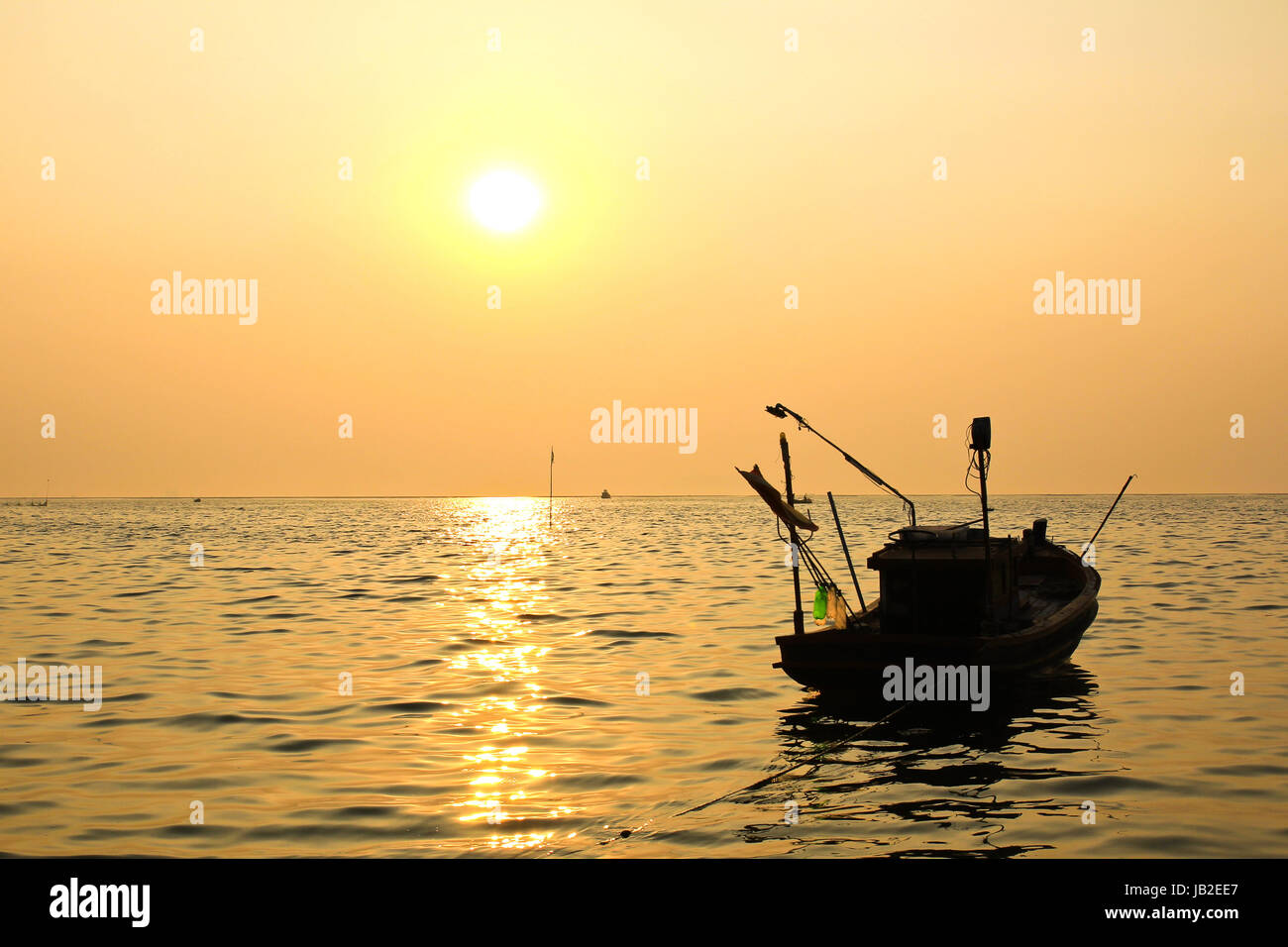 Silhouette of fishing boat at sunset Stock Photo - Alamy