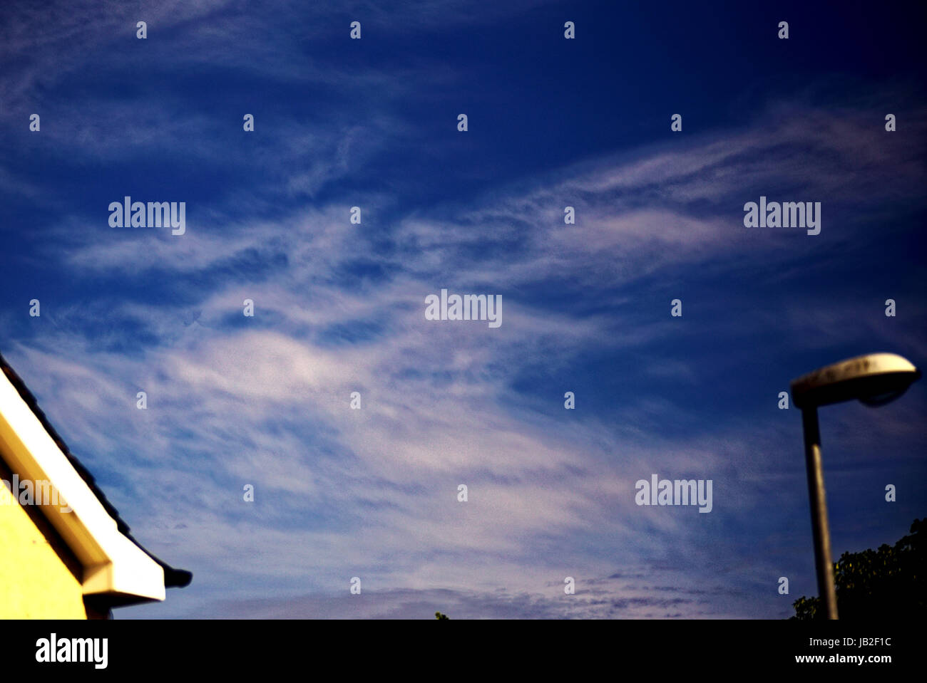 facial Pareidolia blue sky with white clouds that look like Gizmo Mogwai Stock Photo