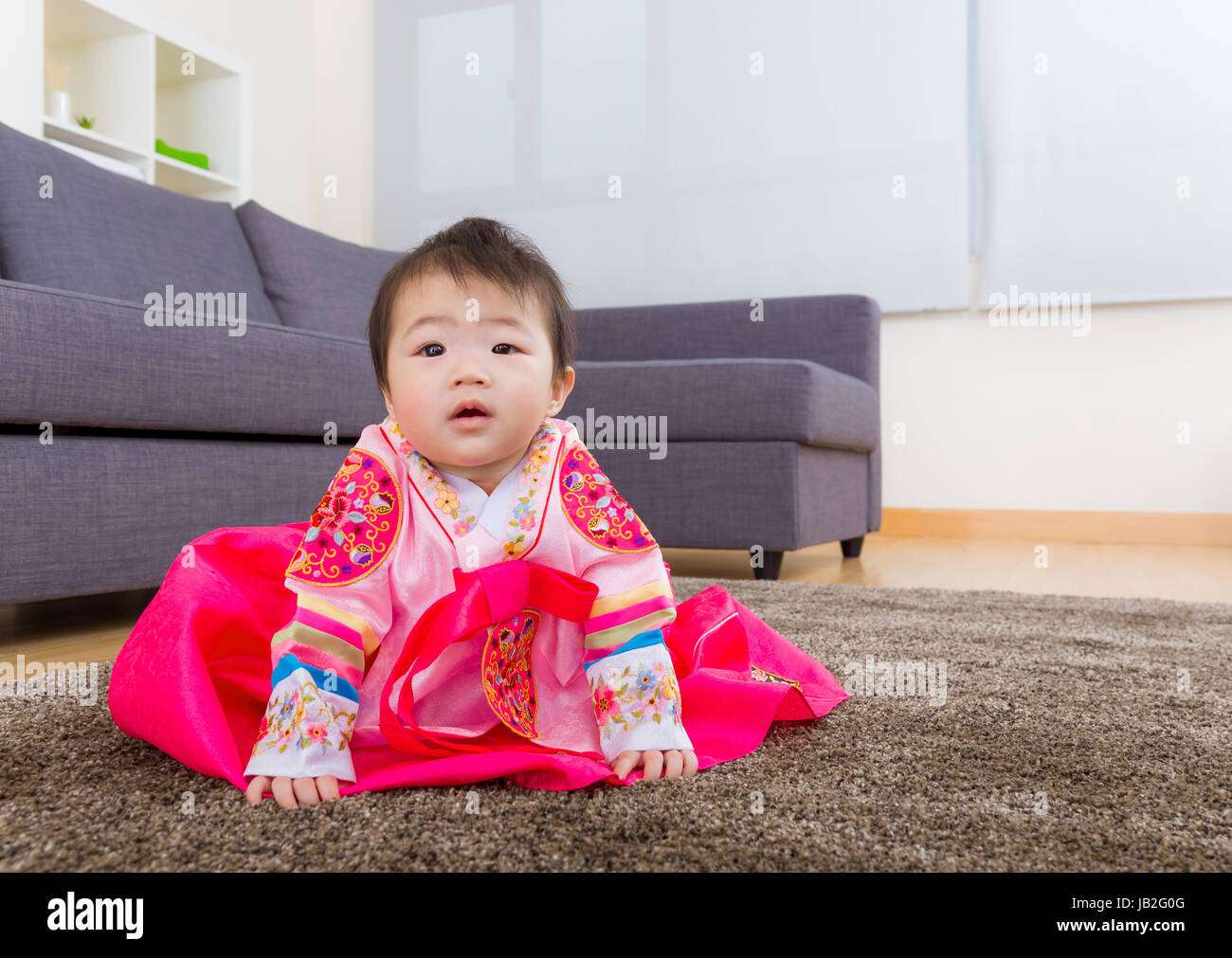 Traditional Korean dressing baby sitting on carpet Stock Photo - Alamy