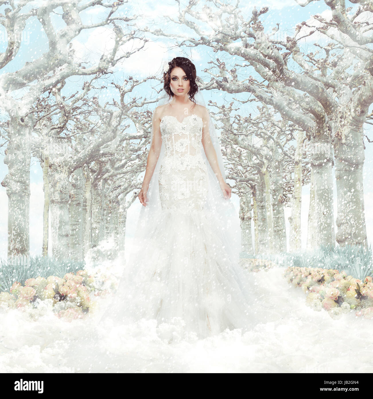 Fantasy. Matrimony. Bride in White Dress over Frozen Winter Trees and  Snowflakes Stock Photo - Alamy