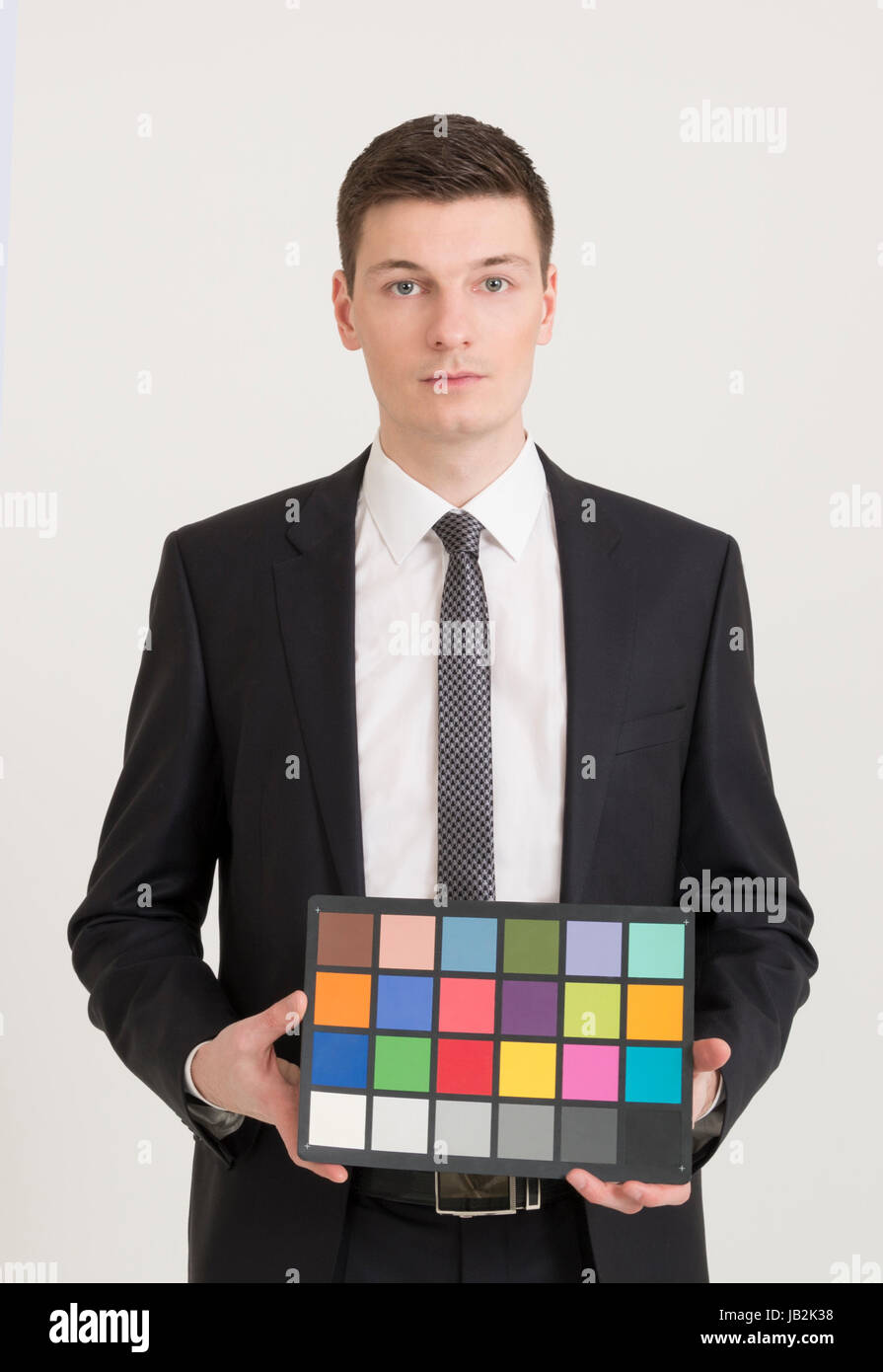 Young photographer holding color checker card Stock Photo
