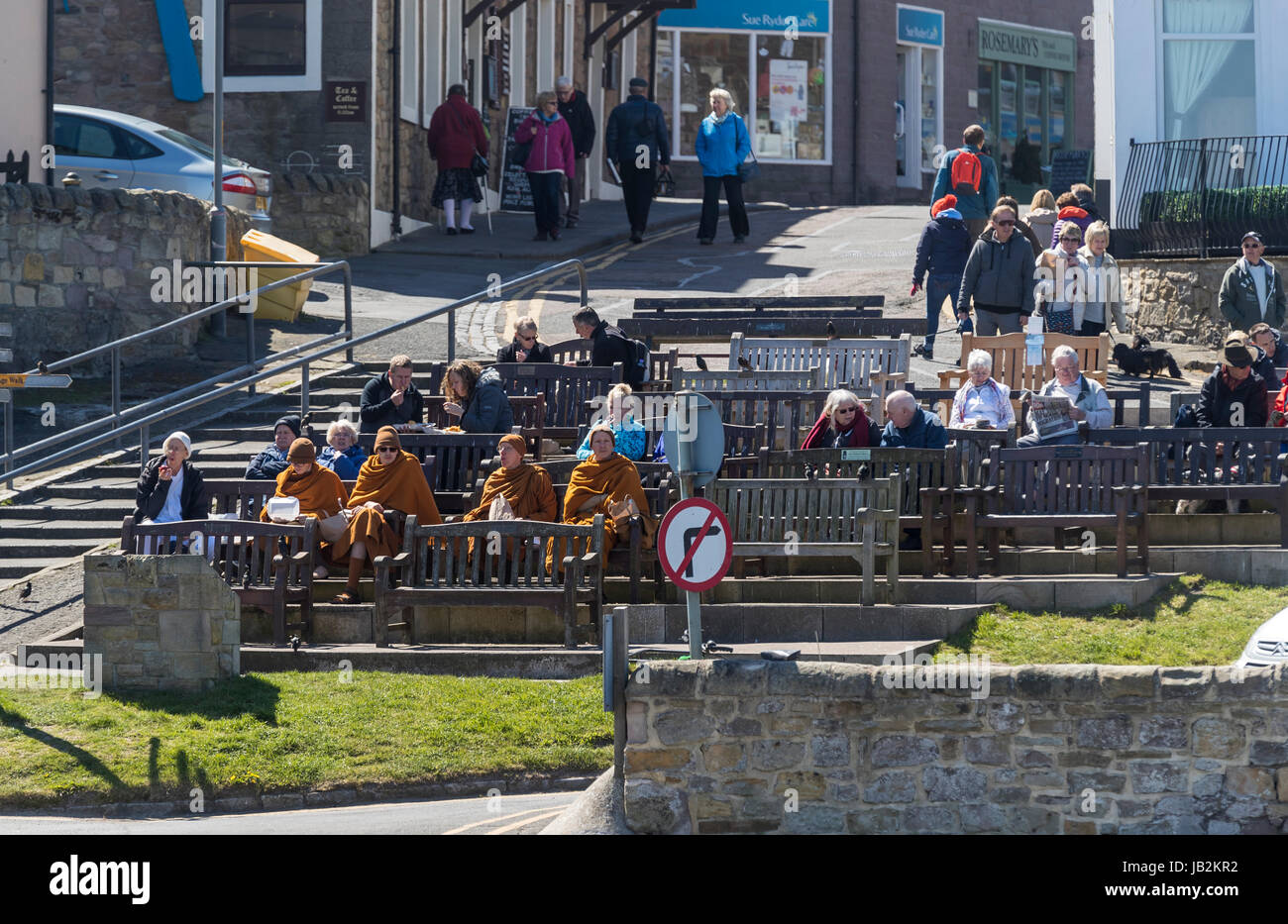 Monks eating fish and chips at Seahouses, Northumberland, UK. Stock Photo