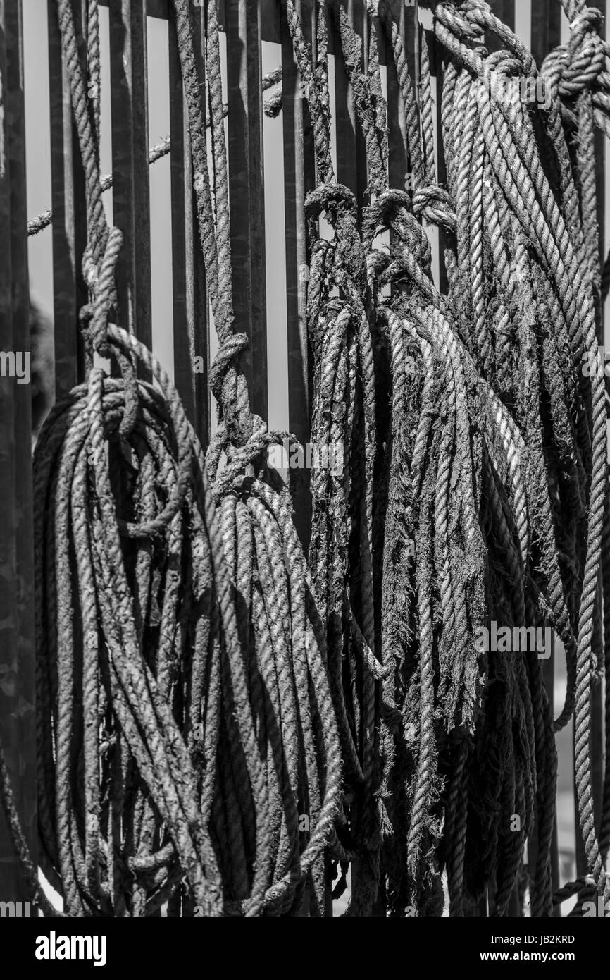 Fishermans ropes hanging on a fence, Seahouses, Northumberland, UK. Stock Photo