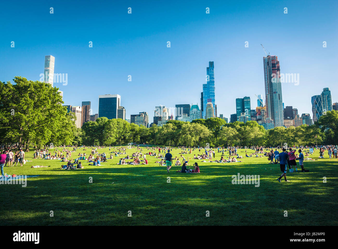 People ejoying free time on Sheep Meadow in Central Park, NewYork City Stock Photo