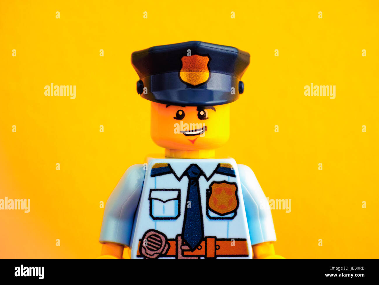 Tambov, Russian Federation - June 03, 2017 Portrait of Lego policeman minifigure on yellow background. Studio shot. Stock Photo