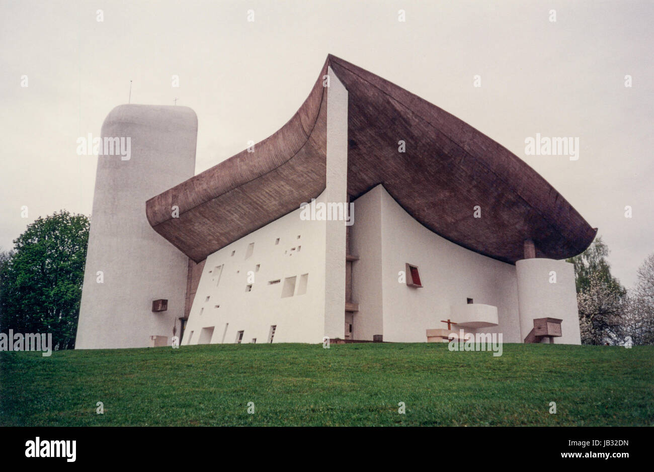 RONCHAMP, FRANCE - APRIL 25, 1996: The chapel of Notre Dame du Haut designed by Le Corbusier in 1954 is a masterpiece of modern religious architecture Stock Photo