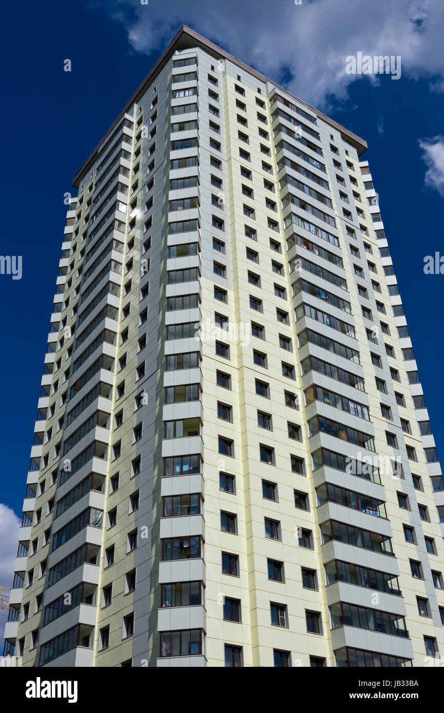 Modern apartment building under blue sky Stock Photo - Alamy