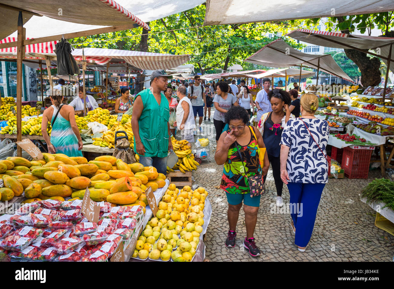 RIO DE JANEIRO - JANUARY 31, 2017: Tropical fruits and vegetables wait for customers browsing the weekly farmer's market in Ipanema Stock Photo