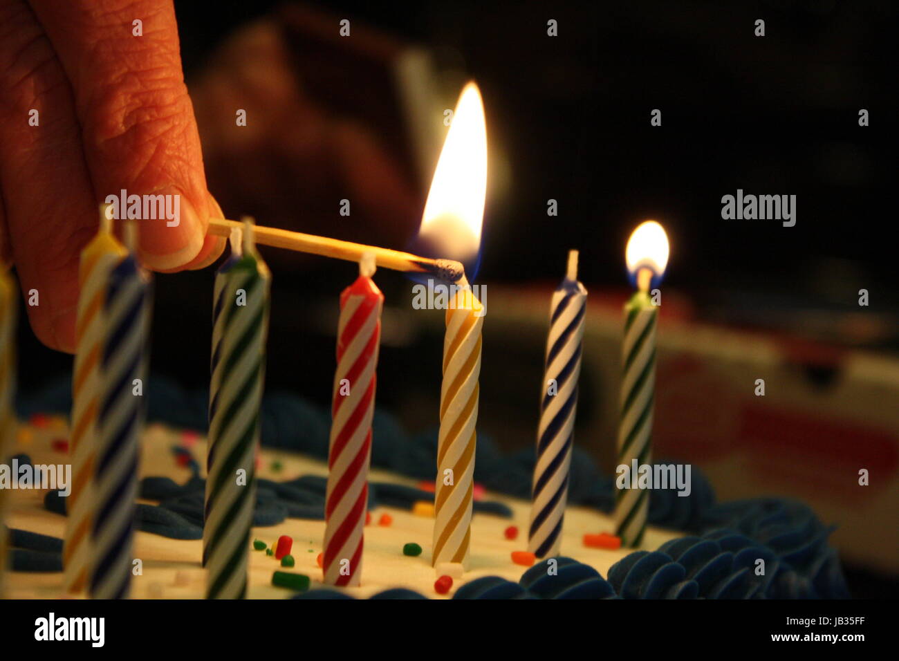 Lighting birthday candles Stock Photo