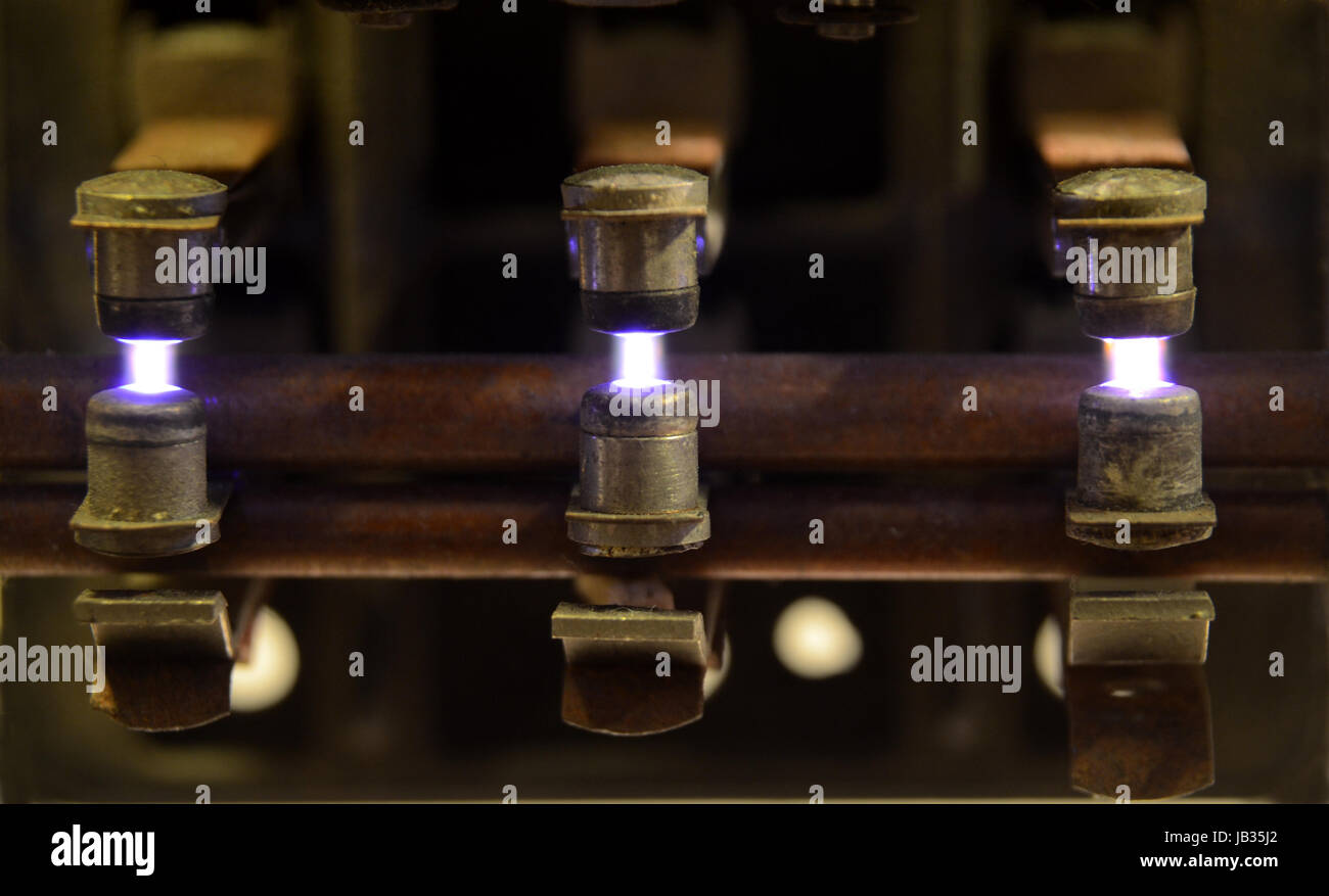 Electric relay with sparks jumping between the contacts, due to