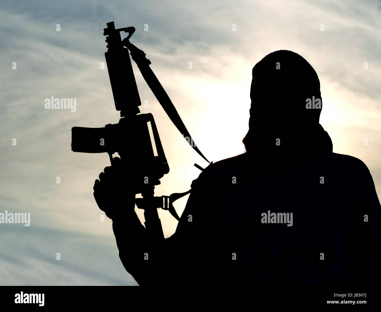 Silhouette of soldier with rifle Stock Photo