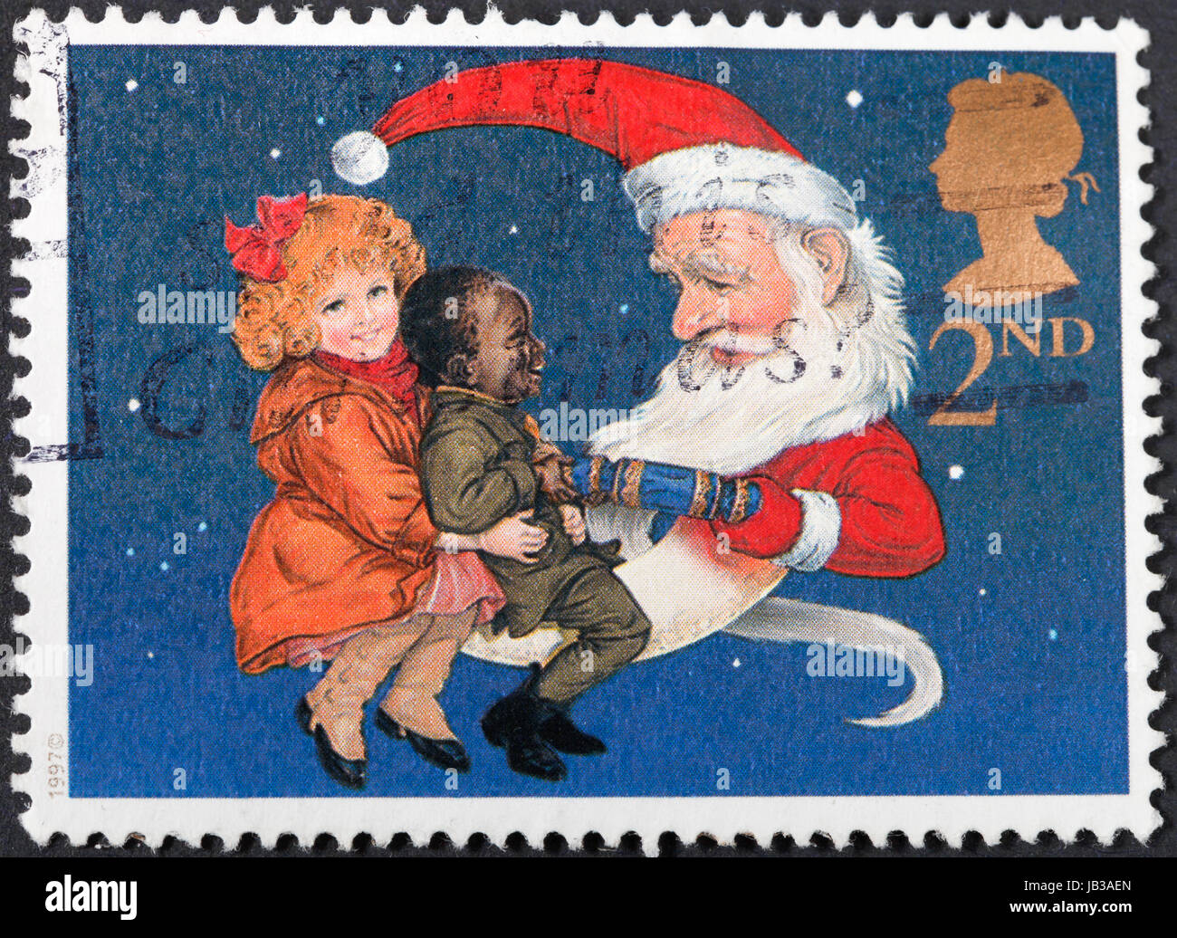 UNITED KINGDOM - CIRCA 1997: A postage stamp printed in the United Kingdom shows Children and Father Christmas pulling a Christmas Cracker , circa 1997 Stock Photo