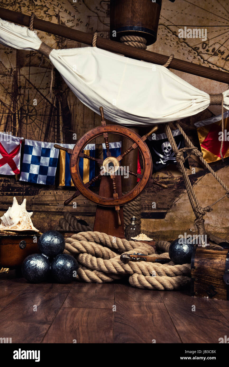 Pirates ship deck with steering wheel and flag Stock Photo Alamy