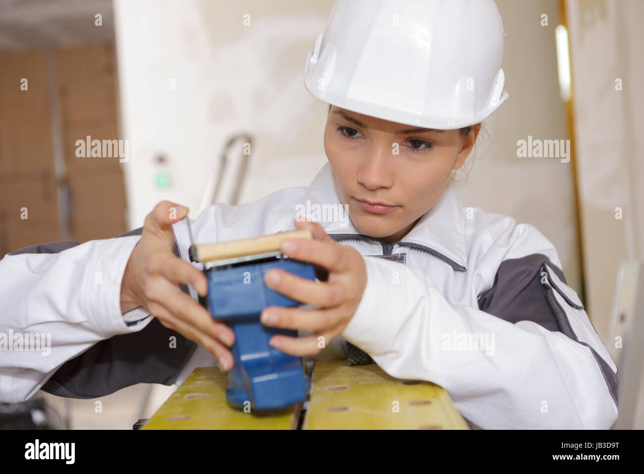 female builder preparing sanding machine Stock Photo Alamy