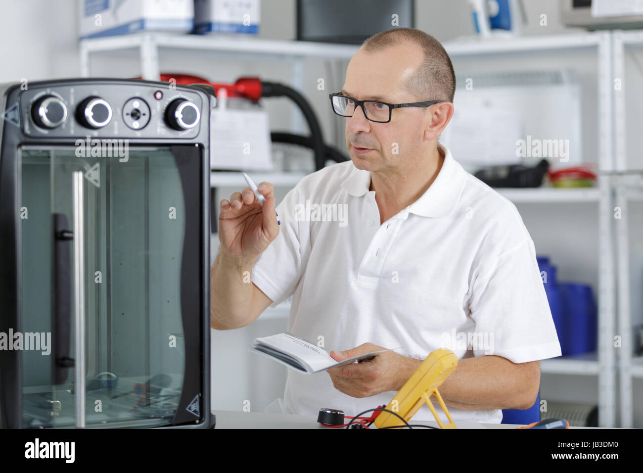handyman repairing electric device at his workplace Stock Photo Alamy