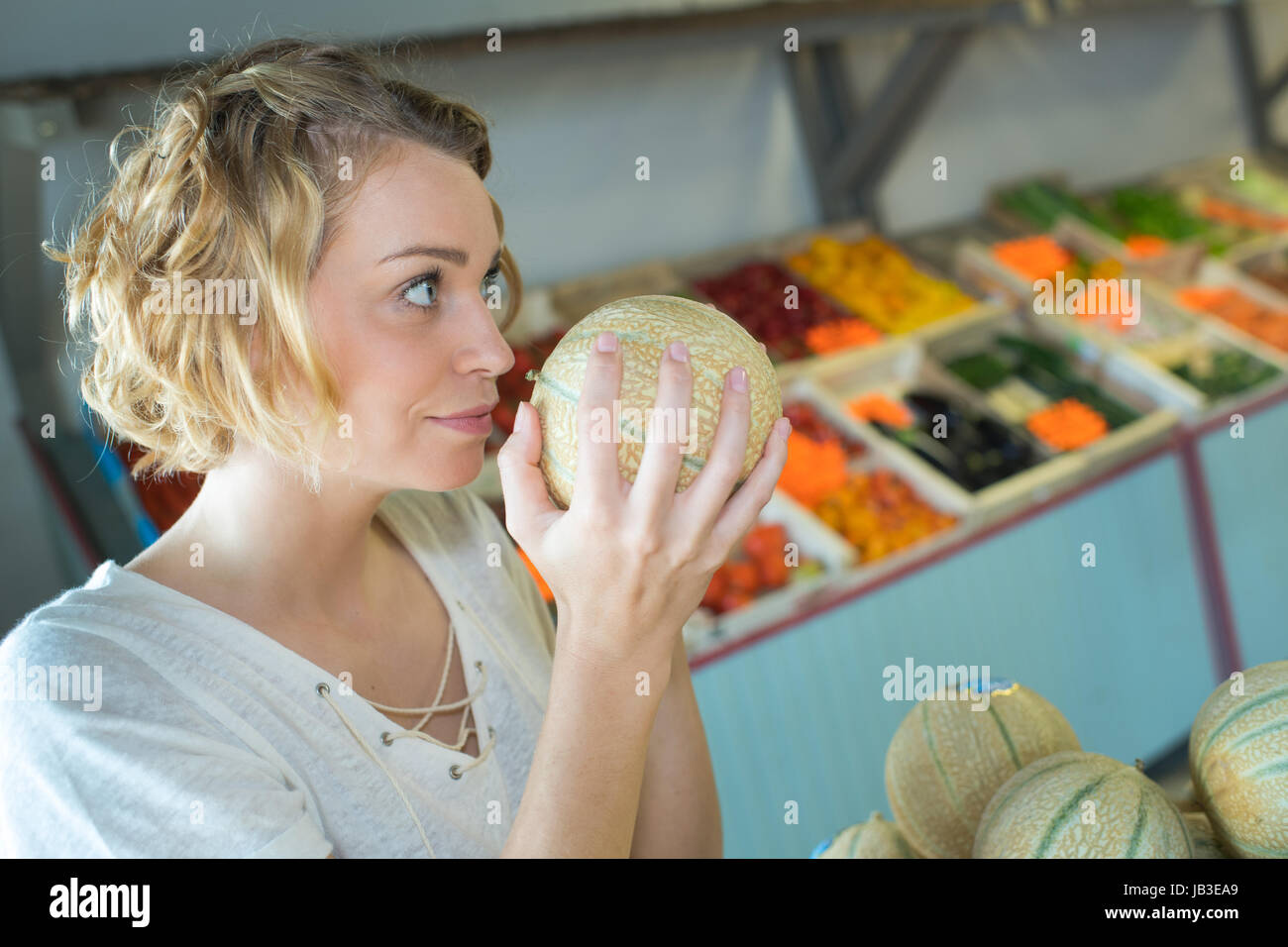 smelling the melon Stock Photo Alamy