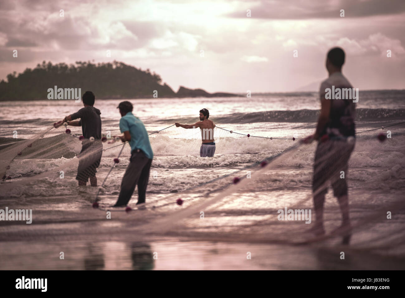 Ilha Do Mel, Paraná, Brazil - June 3, 2017: Native fishermen from Ilha do Mel (Honey Island) pulling the net with fish, for the Feast of the Mullet. Stock Photo