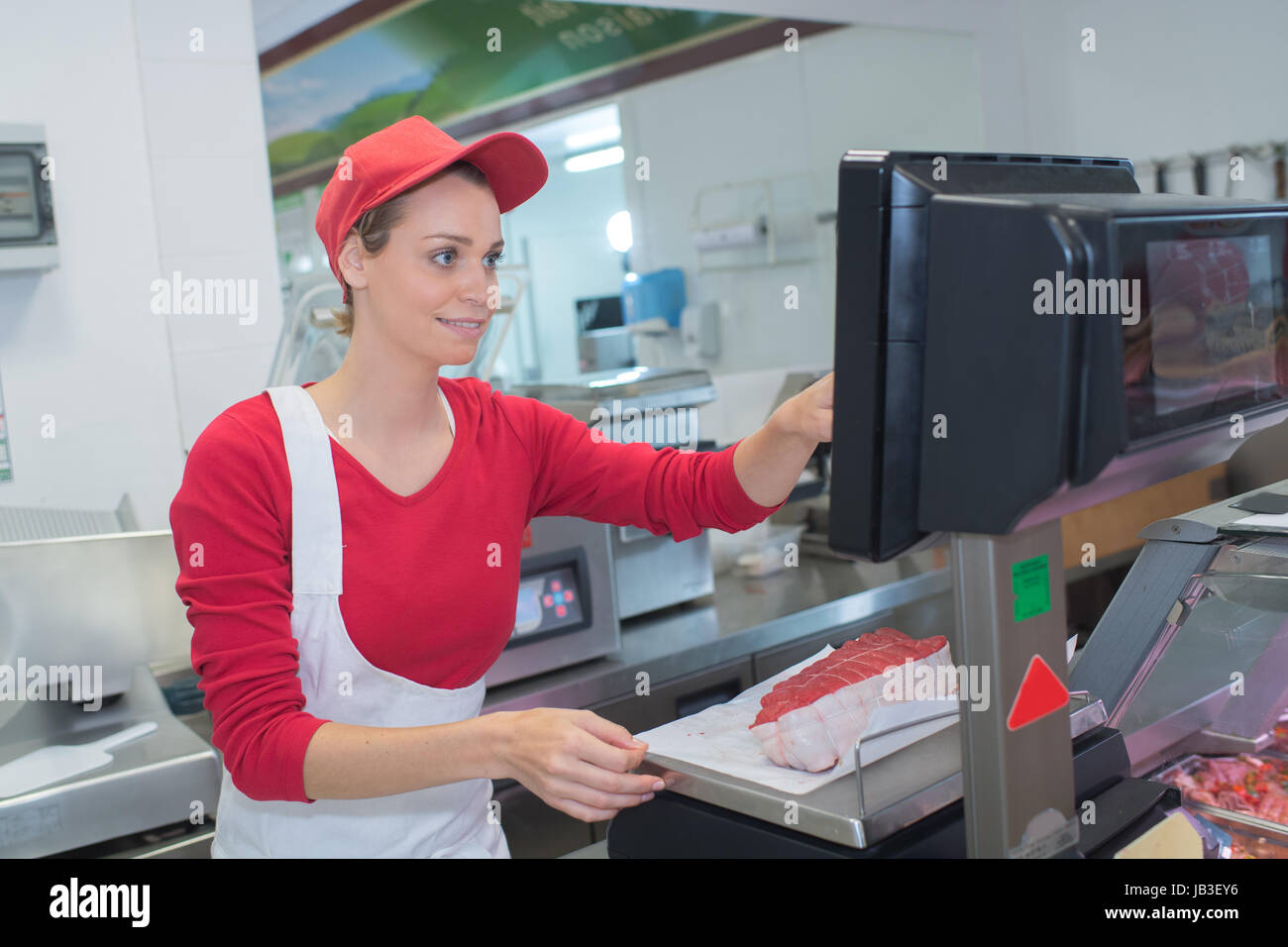 portrait of confident female butcher working Stock Photo - Alamy