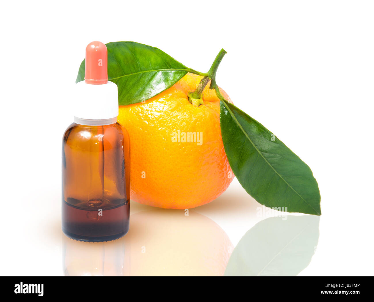 Orange with green leaves and a bottle with dropper isolated on a white background. Alternative medicine concept Stock Photo