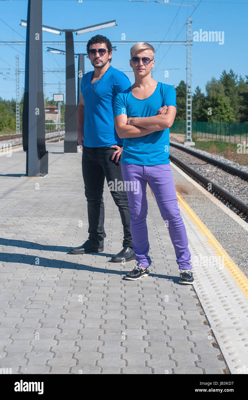Shot of two young men standing on platform Stock Photo - Alamy