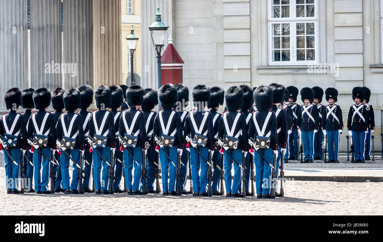 Copenhagen - May 9, 2013: Soldiers of the Danish Royal Life Guards line up for the changing of the guards on the central plaza of Amalienborg palace in Copenhagen, in May 2013. The traditional changing of the guards at Amalienborg palace is a popular tourist attraction in Copenhagen. Stock Photo