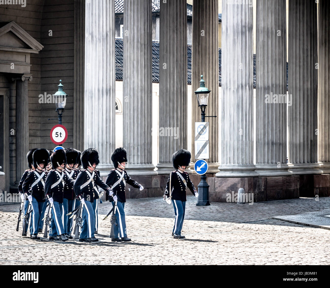 Copenhagen - May 9, 2013: Soldiers of the Danish Royal Life Guards marchi in for the changing of the guards on the central plaza of Amalienborg palace in Copenhagen, in May 2013. The traditional changing of the guards at Amalienborg palace is a popular tourist attraction in Copenhagen. Stock Photo