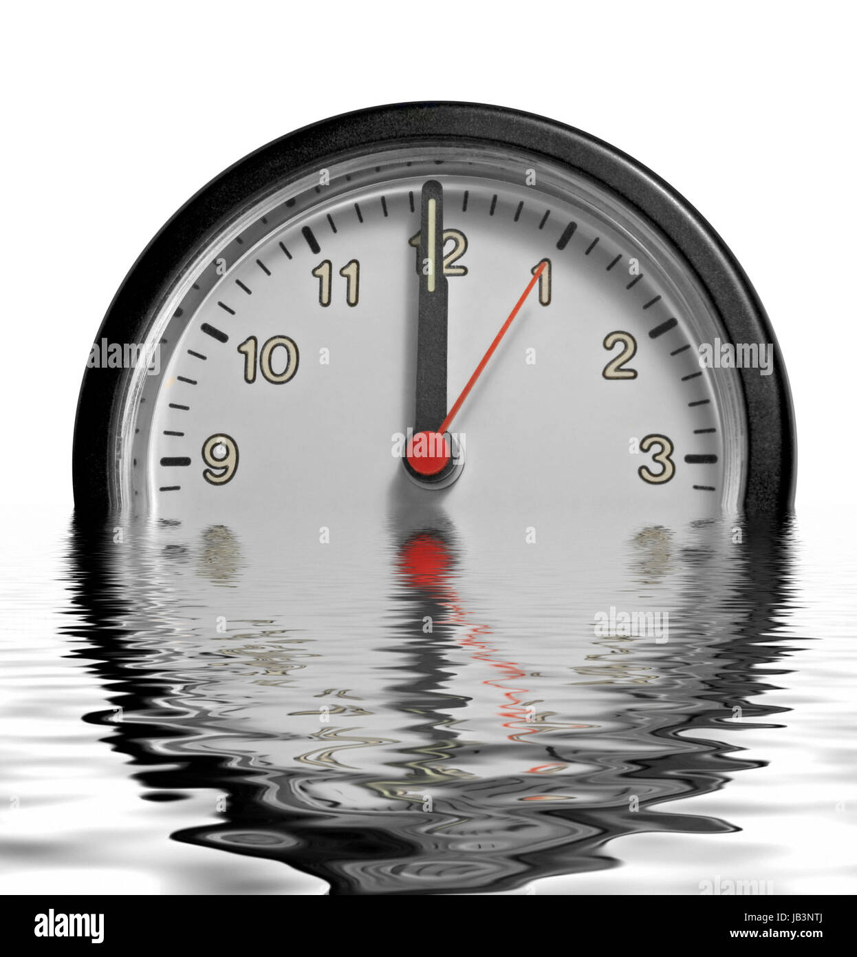 a partly sunken clock face showing past twelve o´clock on reflective water surface in white back Stock Photo