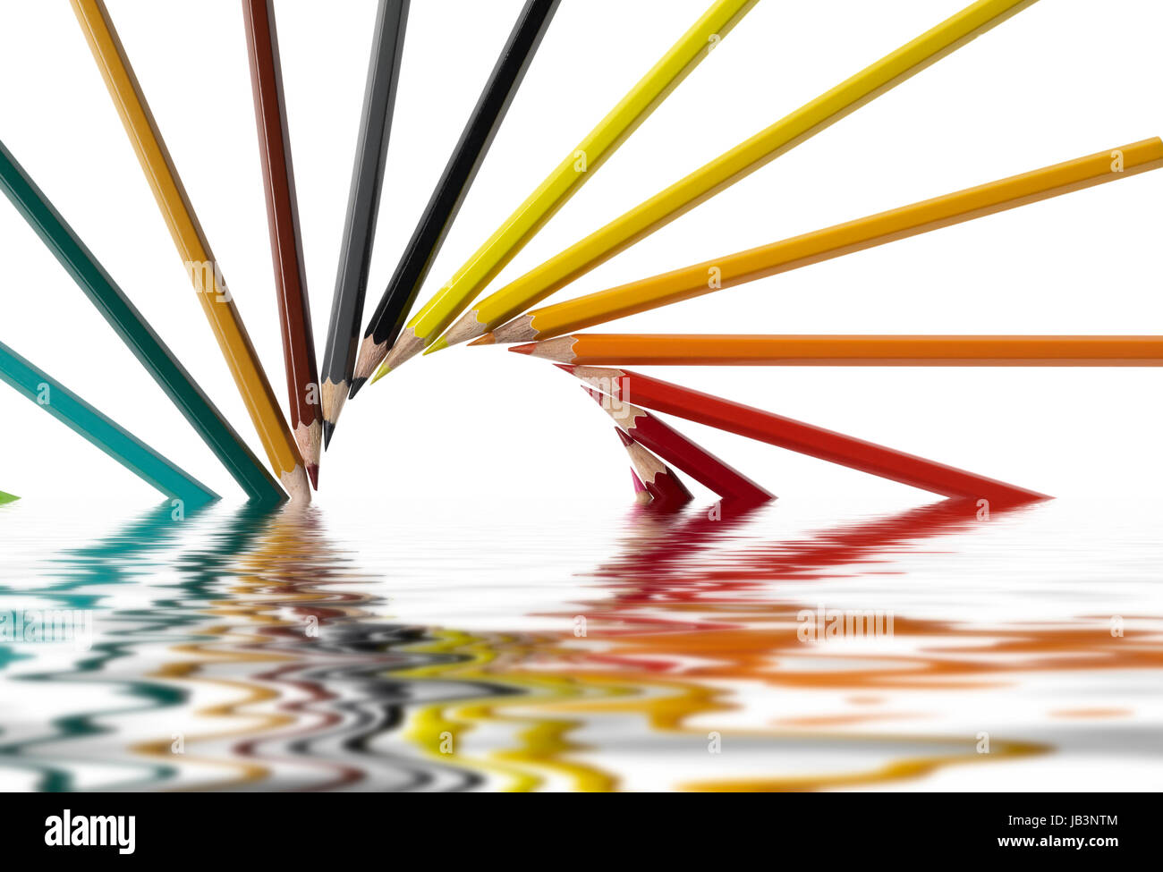 sunken pencil arrangement on reflective water surface in white back Stock Photo