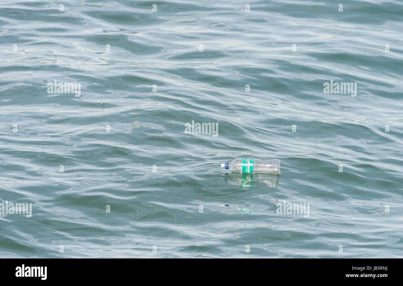 Bottle in the ocean, Plastic pollution in ocean Stock Photo