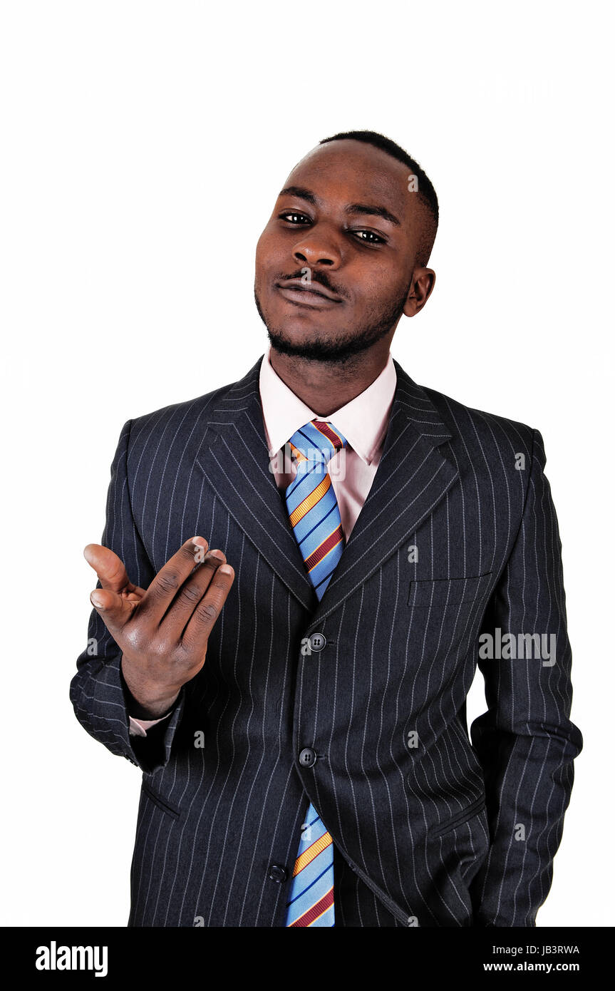 A young black business man standing in a suit and tie, gesturing with ...
