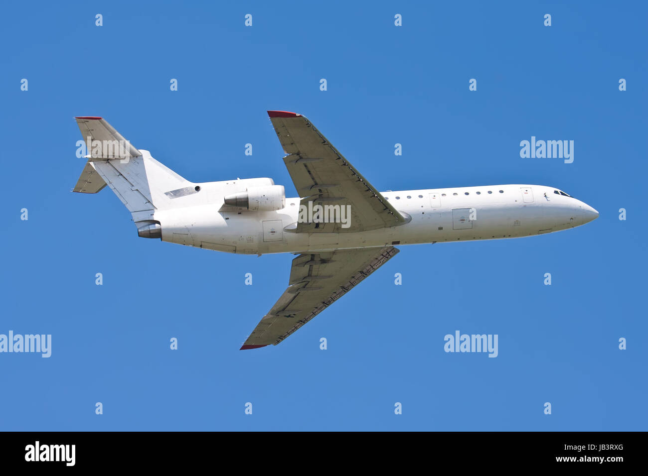 Beautiful white passenger airplane in blue sky Stock Photo - Alamy