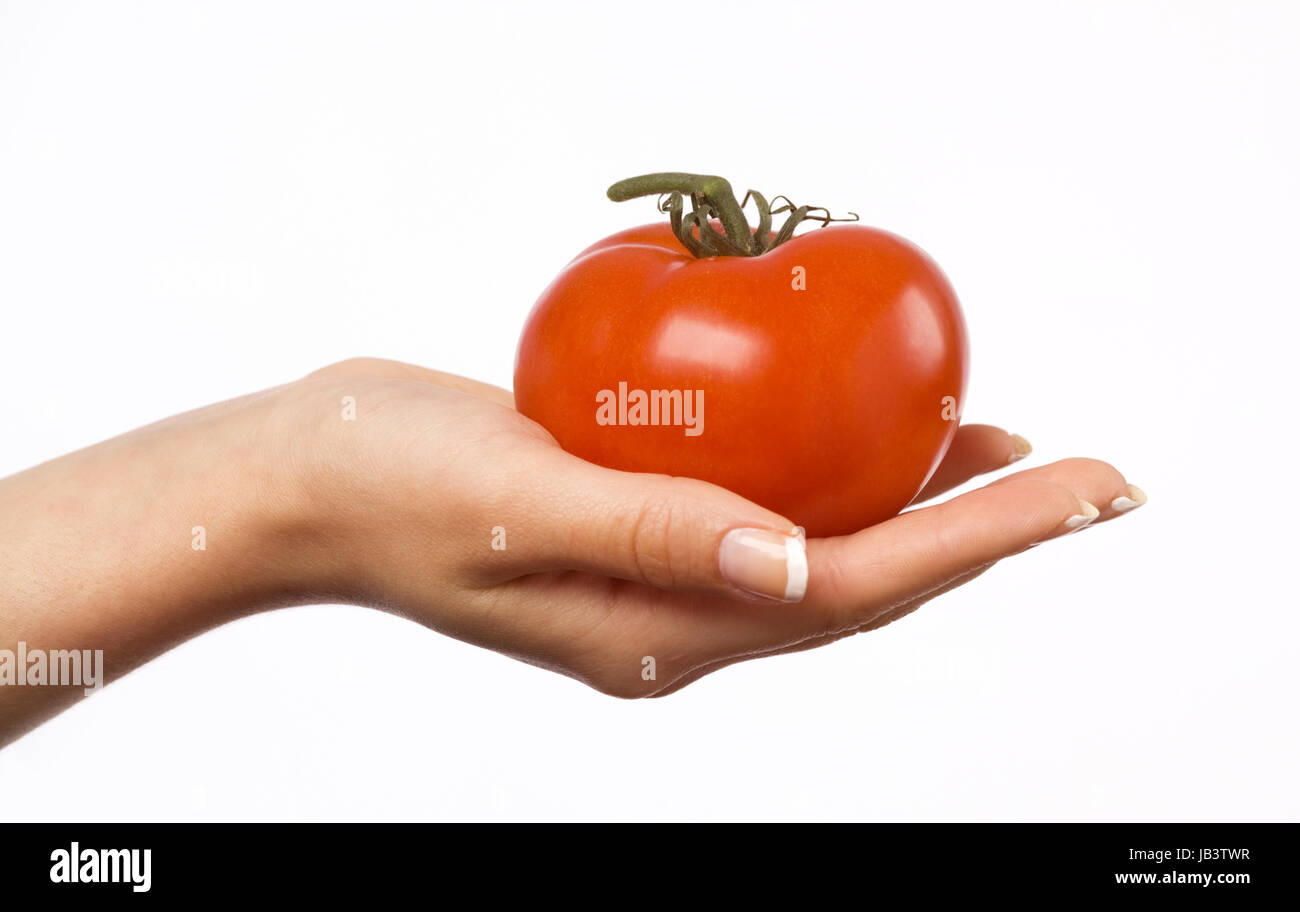 Woman's hand holding a red tomato Stock Photo - Alamy