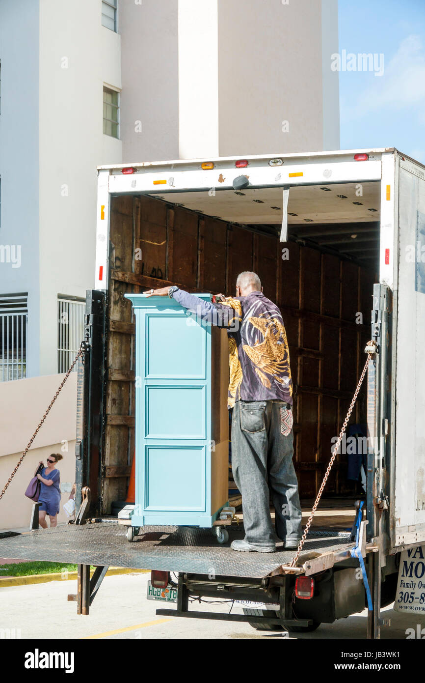 Miami Beach Florida,street scene,moving truck,furniture,unloading,Black Blacks African Africans ethnic minority,adult adults man men male,mover,job,vi Stock Photo