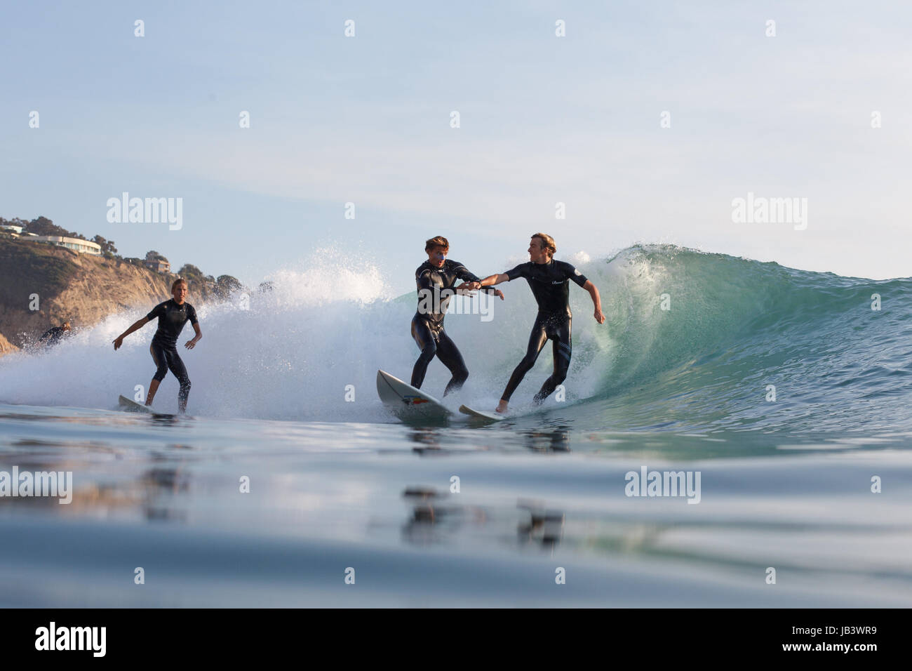 Overcrowded waves in Southern California lead two surfers to engage in a fistfight while surfing at Black's Beach. Stock Photo