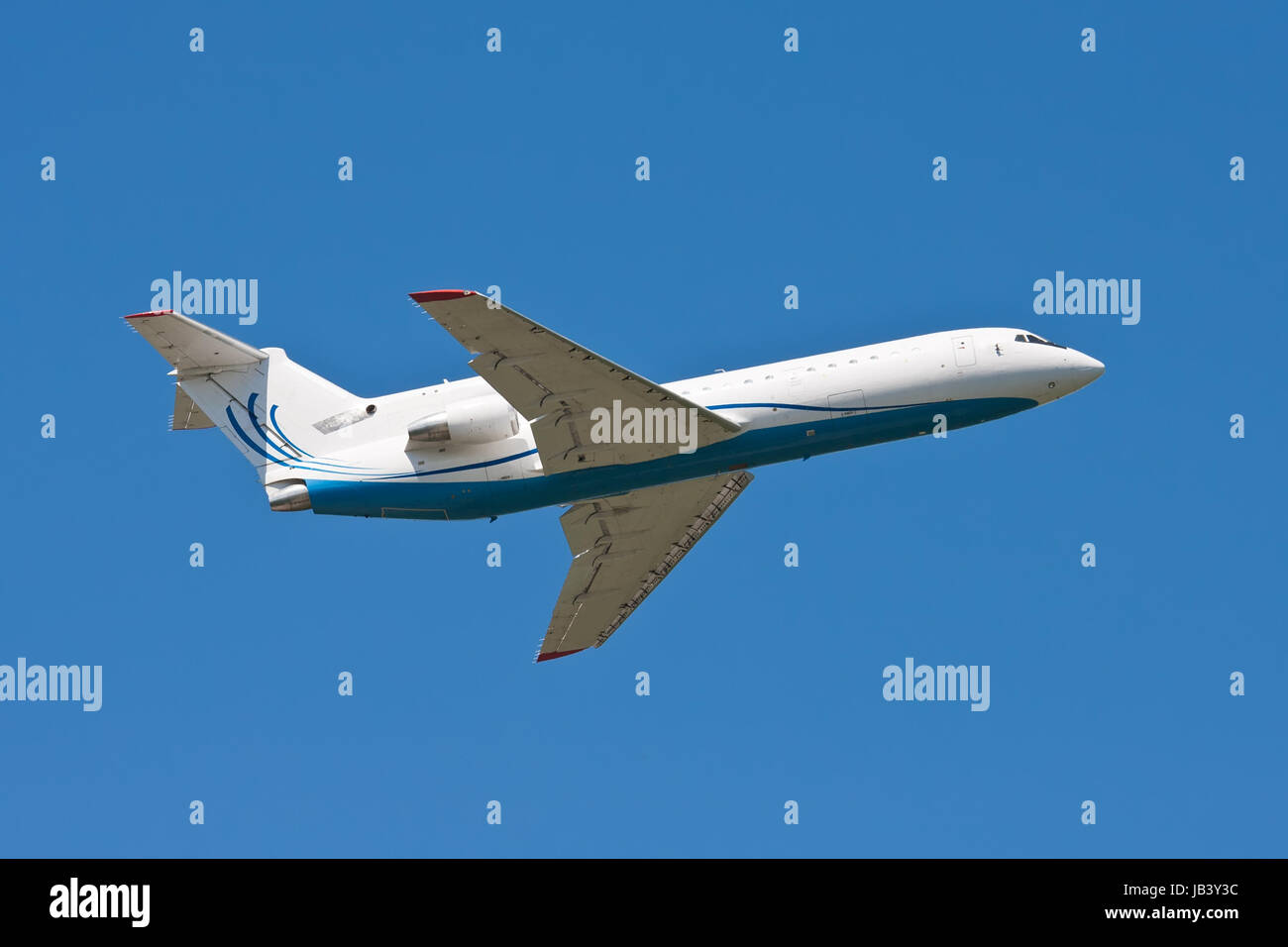 Beautiful white passenger airplane in blue sky Stock Photo - Alamy